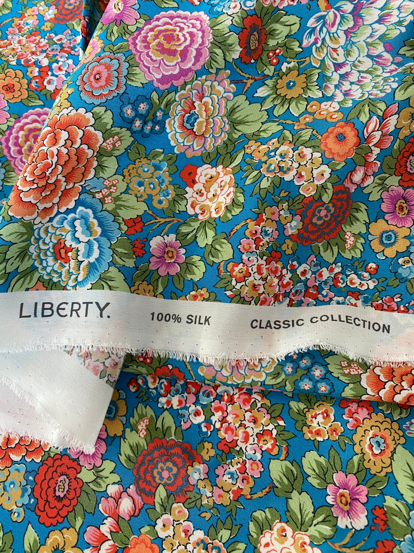 Luxury floral silk scrunchie with turquoise, orange, and pink - slim