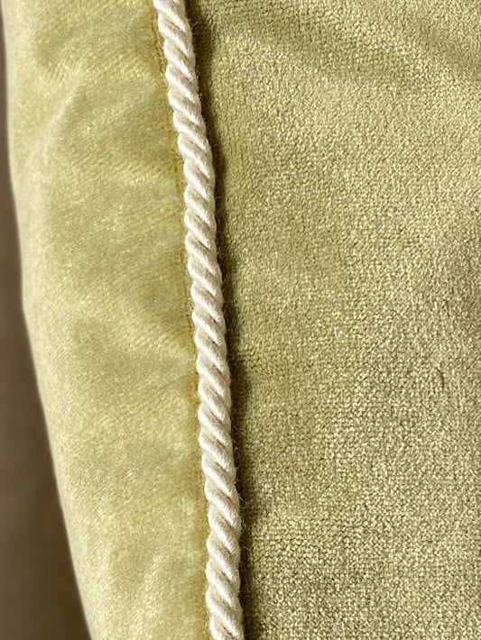 Close up of cord trim on moss green velvet square cushion