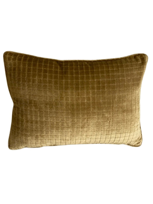 Gold velvet textured cushion on a white background