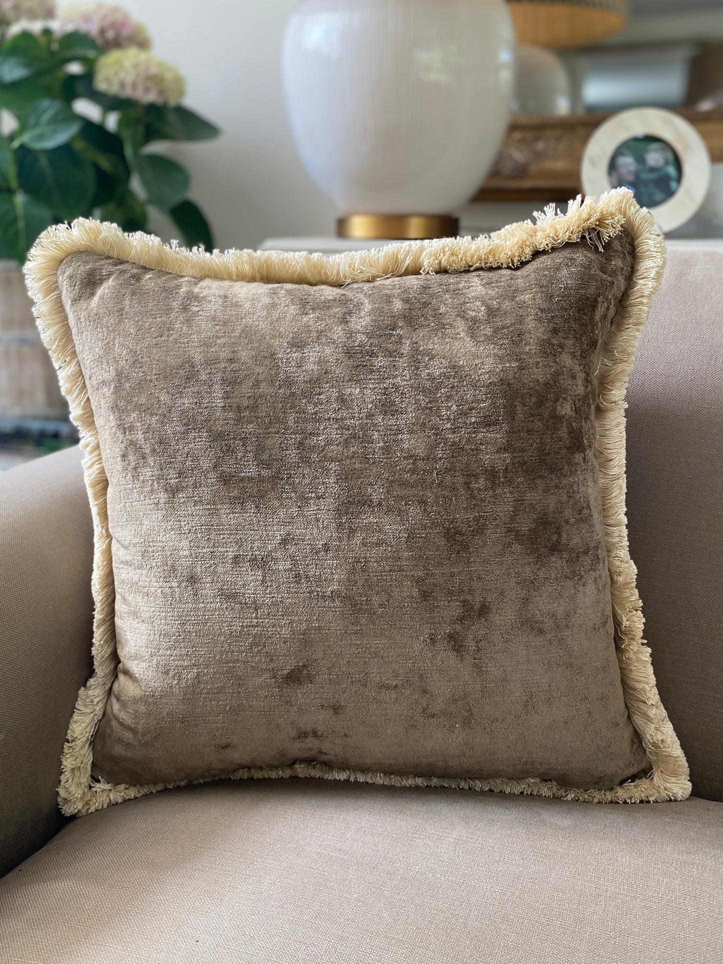 Plump brown square vintage feel cushion with fringing, measuring 48 x 48cm