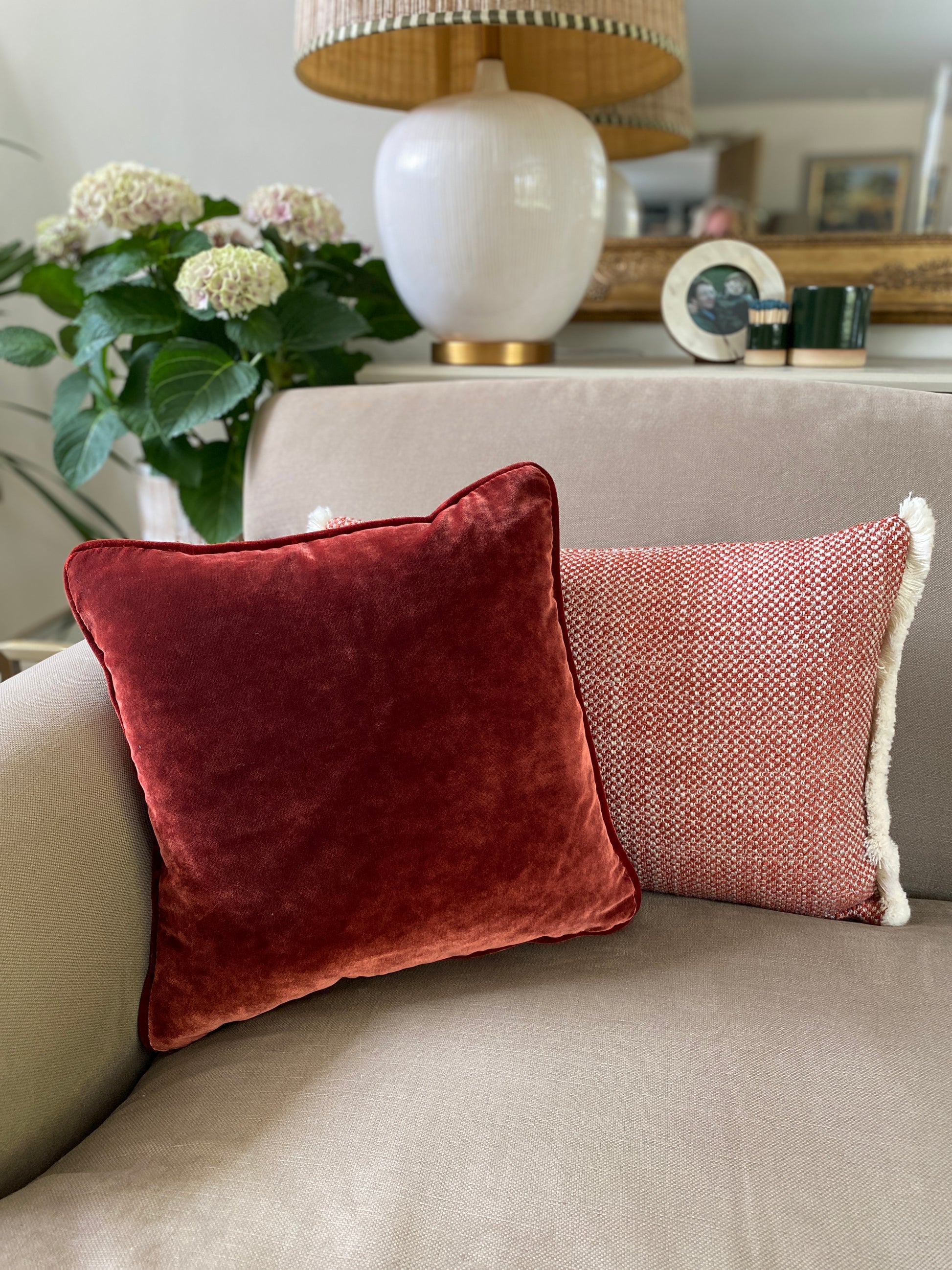 A chestnut velvet square cushion sits perfectly with the chestnut and cream rectangular woven cushion for a cosy autumnal feel.