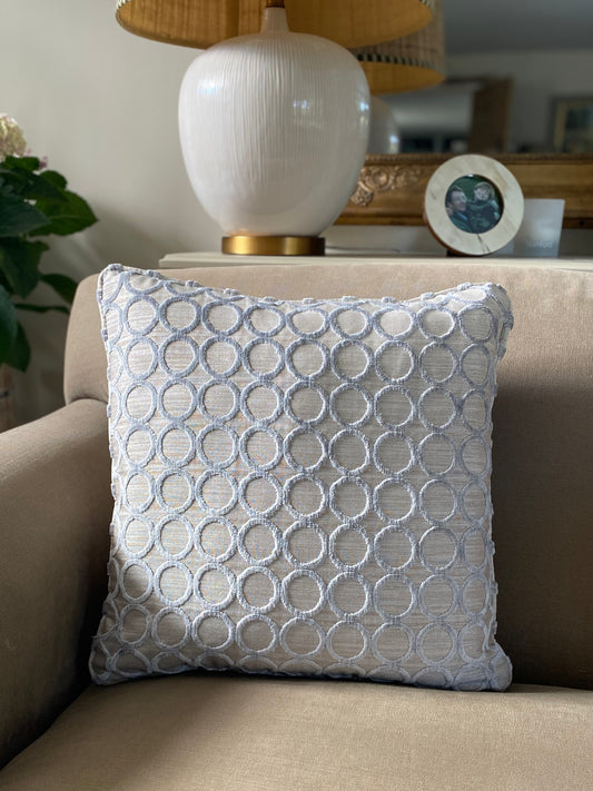 Silver grey cut pile velvet square cushion with silver grey background and circle design. Measures 45 x 45cm and has piping around the edges.