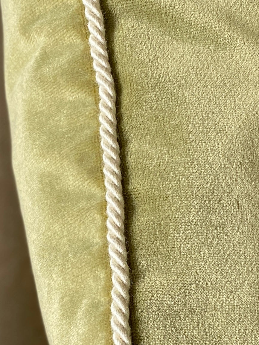 Close up of cord trim on moss green velvet square cushion 