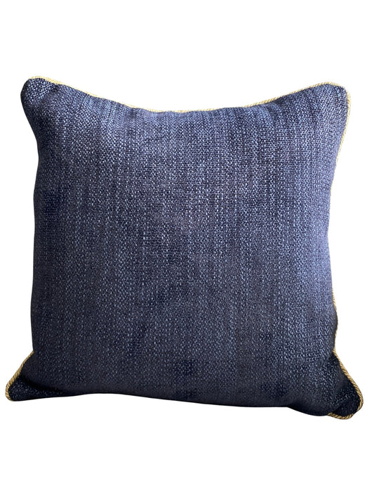 Navy textured cushion with gold trim piping on a white background