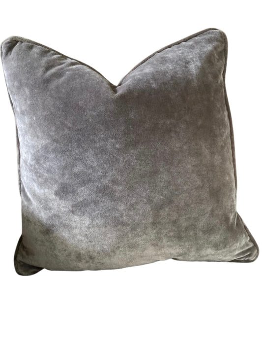 Grey velvet cushion on a white background
