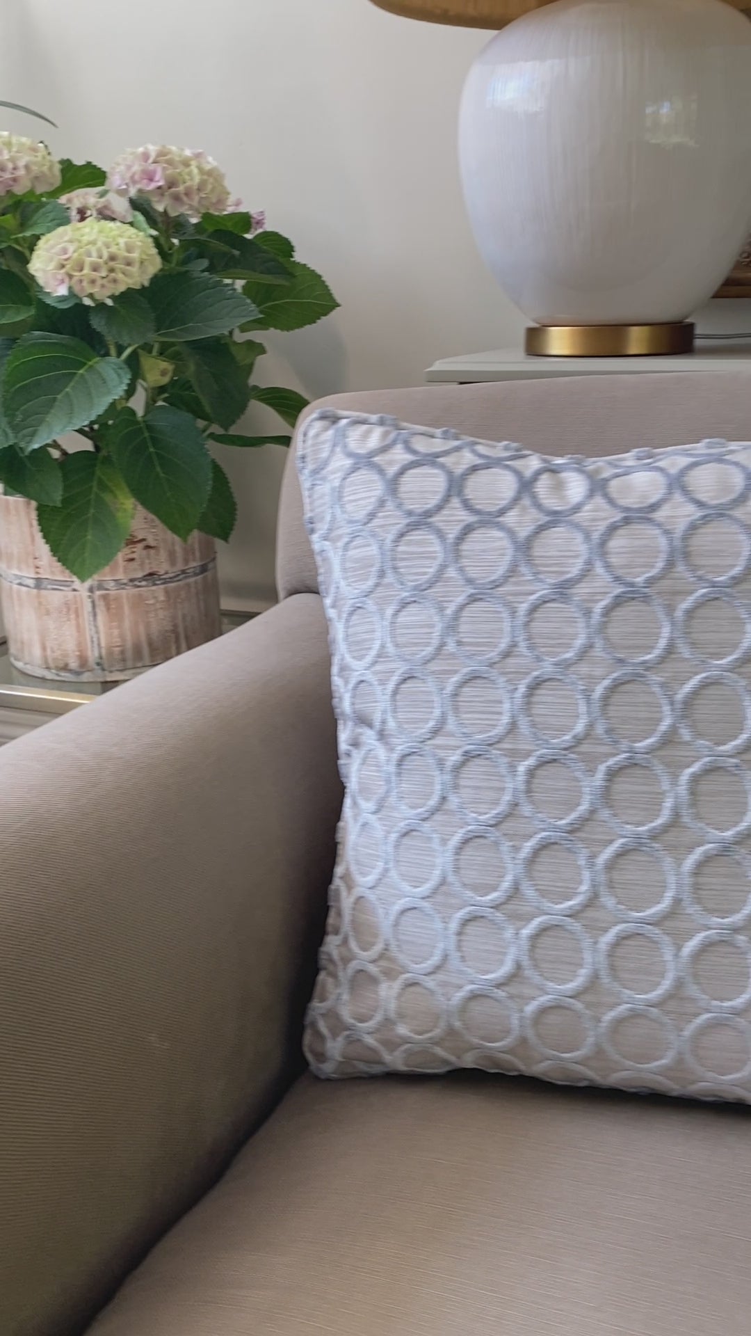 Silver grey cut pile velvet square cushion with silver grey background and circle design. Measures 45 x 45cm and has piping around the edges.